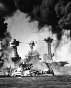 Battleship USS West Virginia sunk and burning at Pearl Harbor on Dec. 7, 1941. In background is the battleship USS Tennessee.